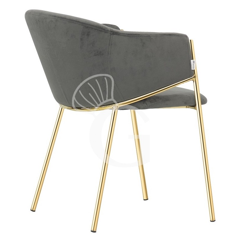 Silla con estructura de metal acabado latón y tapizado en tejido o terciopelo